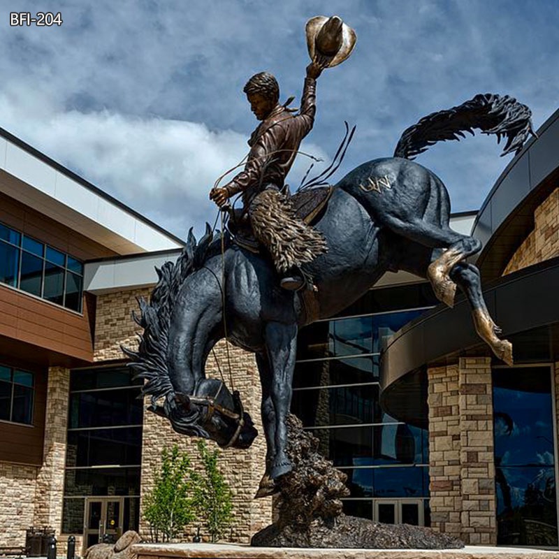 bronze cowboy on bucking horse statue