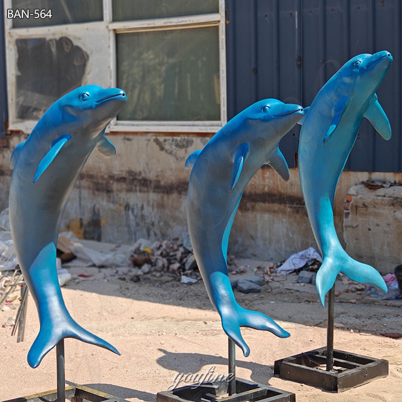 brass dolphin statues