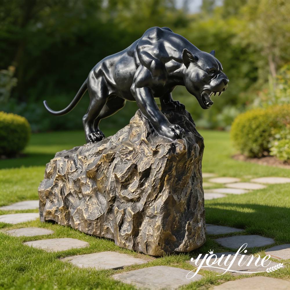 bronze panther statue on rock